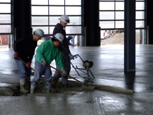 Dynamic Concrete Pumping concrete finishers and placers working together at a job site