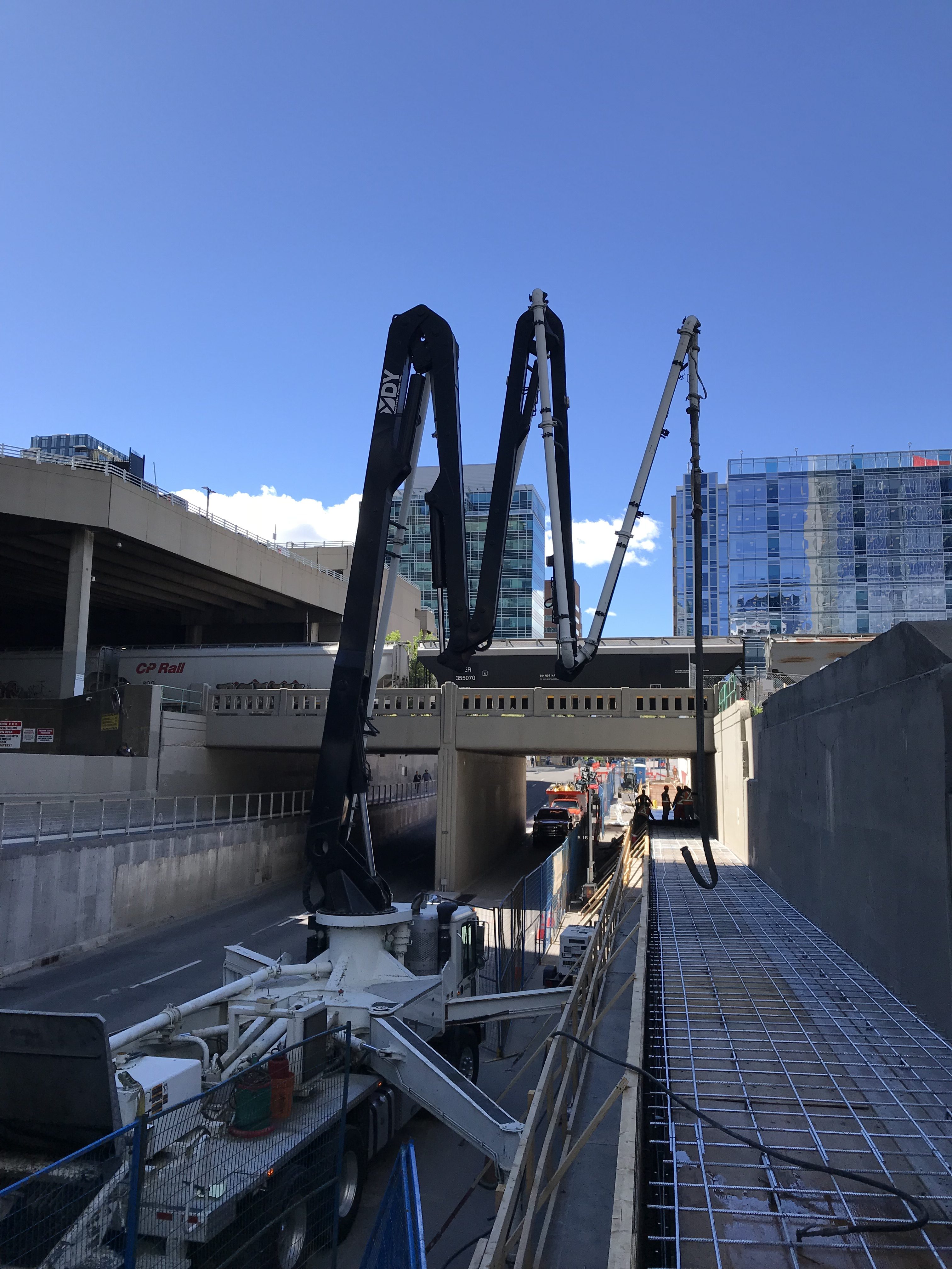 Dynamic Concrete Pumping using their 33-M concrete boom pump on a project next to a train